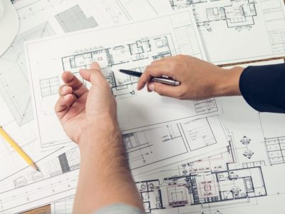 Engineer and architect discussing about blueprint layout design of  electricity plan before construction