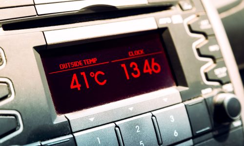 Summer hot temperatures. High temperature on car dashboard display.